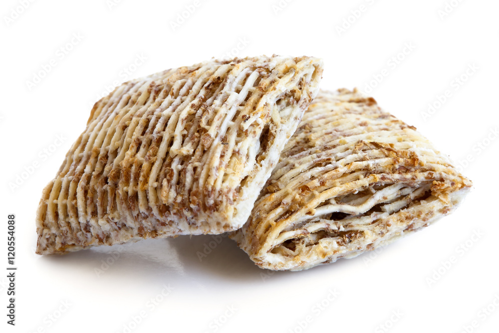 Two mini shredded wholegrain biscuits isolated on white.