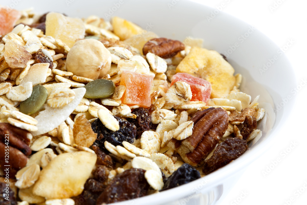 Detail of breakfast bowl of fruit and nut muesli  on white.