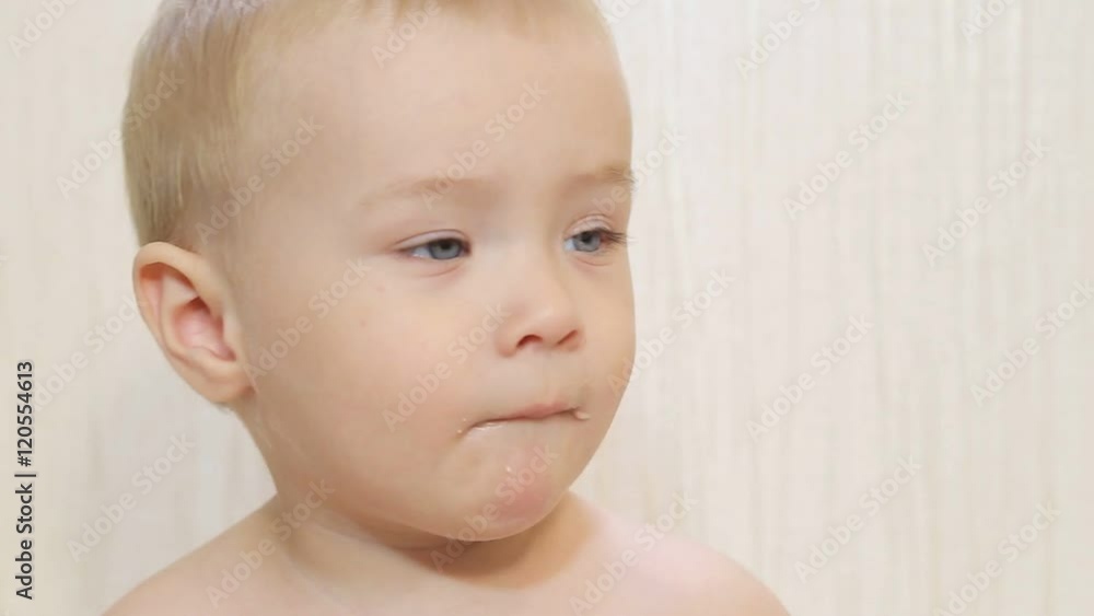 Mother Spoon Feeding A Boy