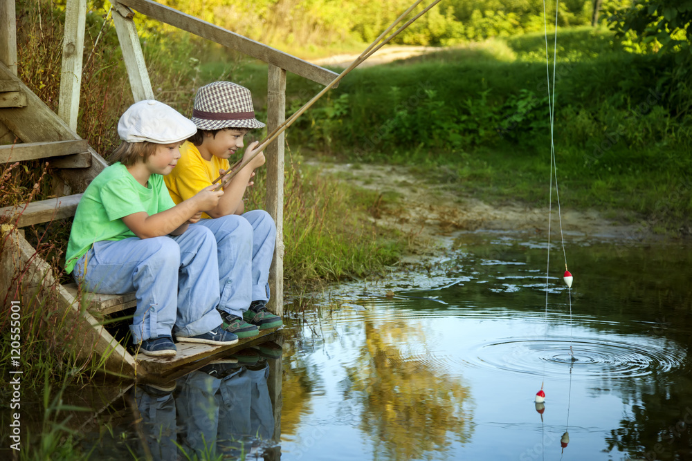 Happy boys go fishing on the river, Two children of the fisherma Happy boys go fishing on the river, Two children of the fisherma