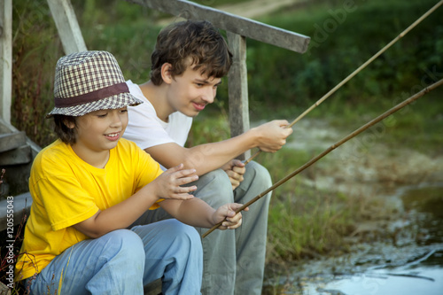 Happy boys go fishing on the river, Two children of the fisherma