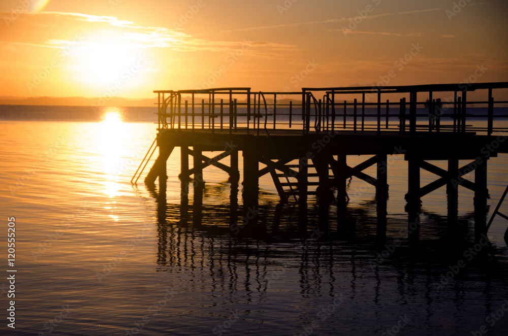 Sunrise with a jetty in front