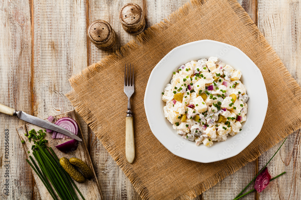 Traditional German potato salad with cucumber, onion and mayonna Traditional German potato salad with cucumber, onion and mayonna