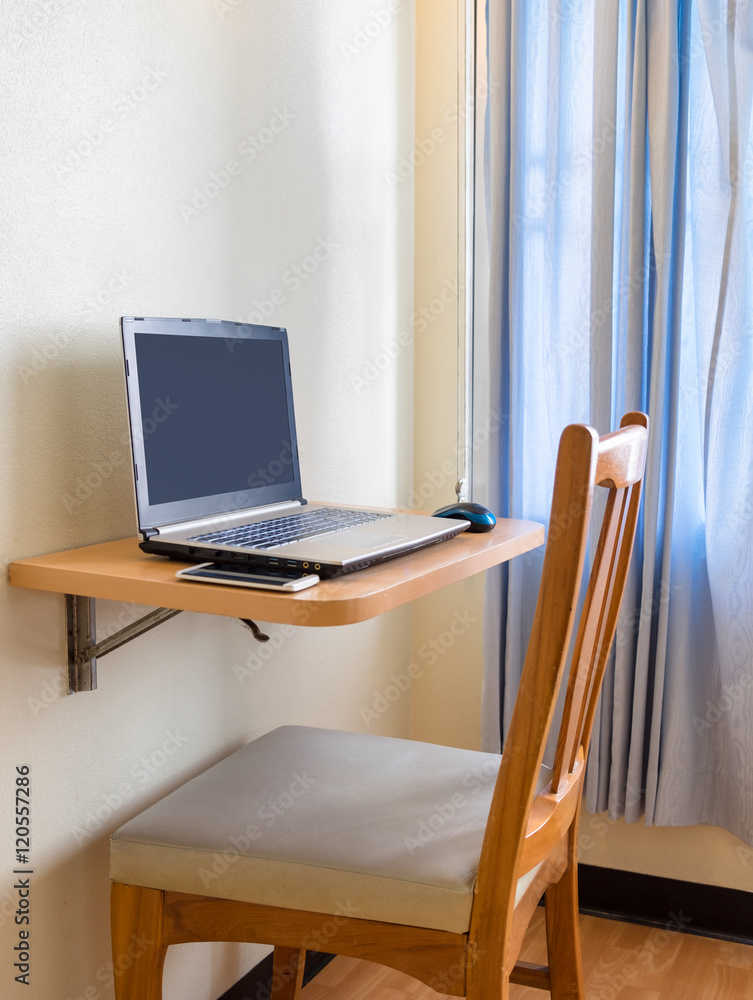 Notebook with smartphone on table wooden float beside window Notebook with smartphone on table wooden float beside window