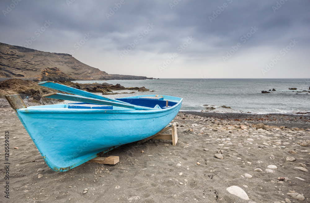 boat moored on the beach before the storm