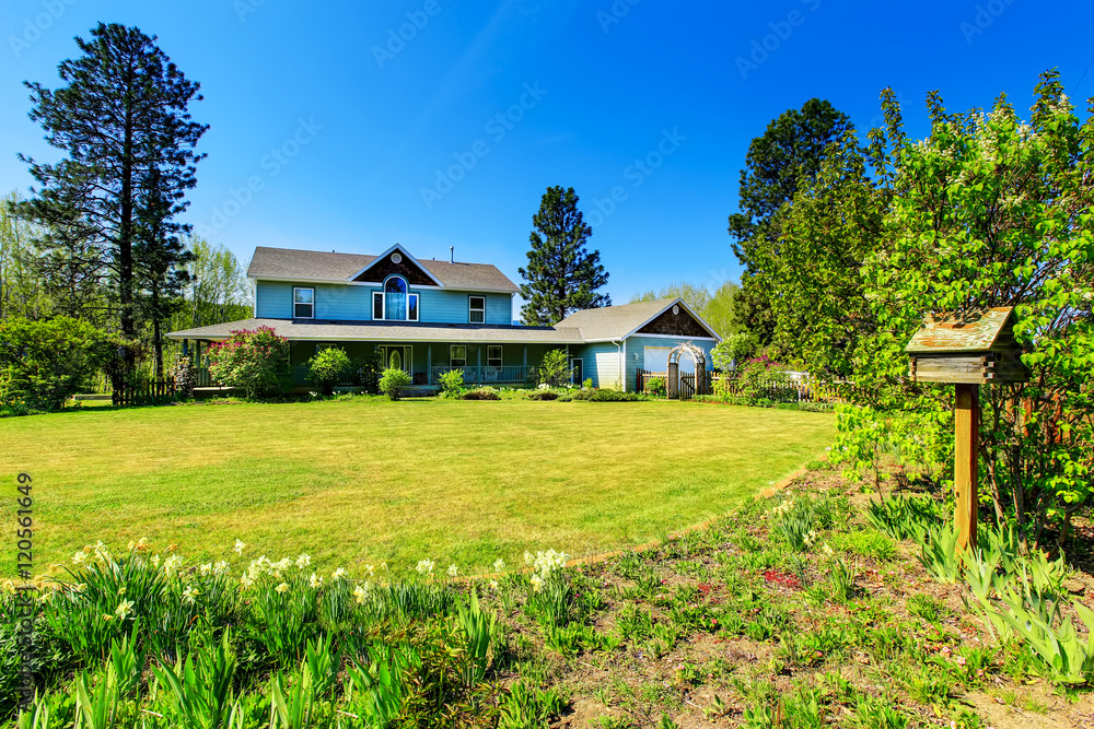 Fototapeta premium Beautiful curb appeal of large blue country house