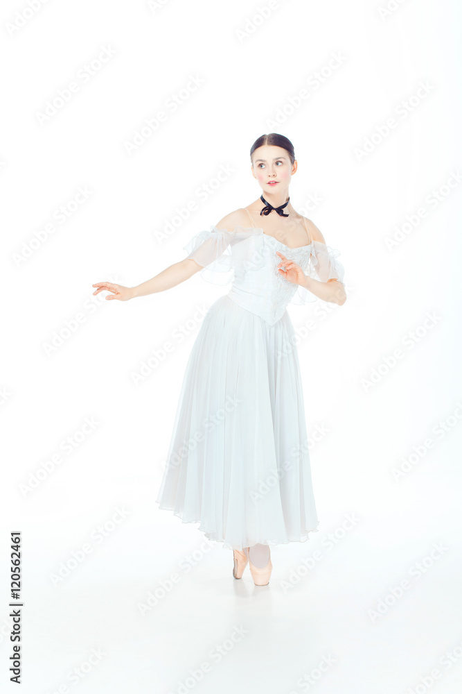 Ballerina in white dress posing on pointe shoes, studio background. Ballerina in white dress posing on pointe shoes, studio background.