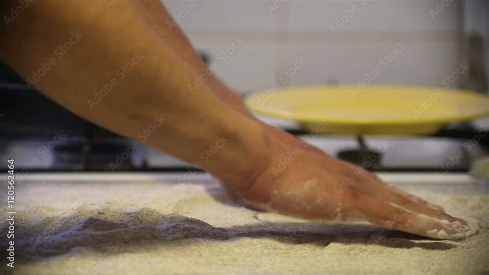 Baker hands kneading dough in flour on table Baker hands kneading dough in flour on table