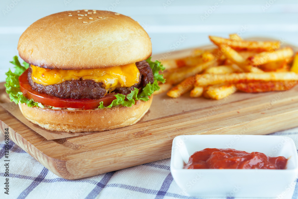 burger and french fries on wooden table burger and french fries on wooden table