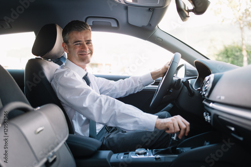 Businessman driving a luxury car © StockPhotoPro