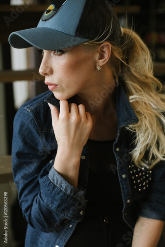 blond girl in a baseball cap.