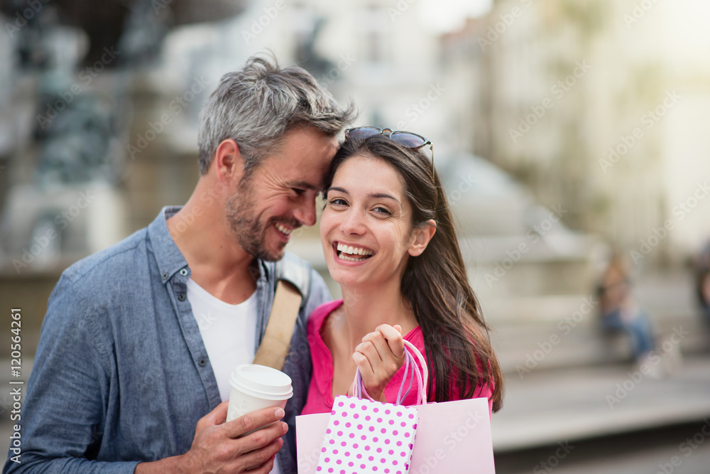 A cheerful tourist couple visiting a city during their vacation A cheerful tourist couple visiting a city during their vacation