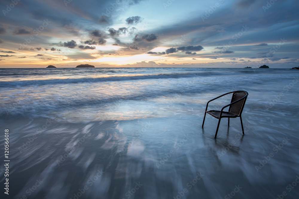 Chair in sea at sunset, long time of shutter speed Chair in sea at sunset, long time of shutter speed
