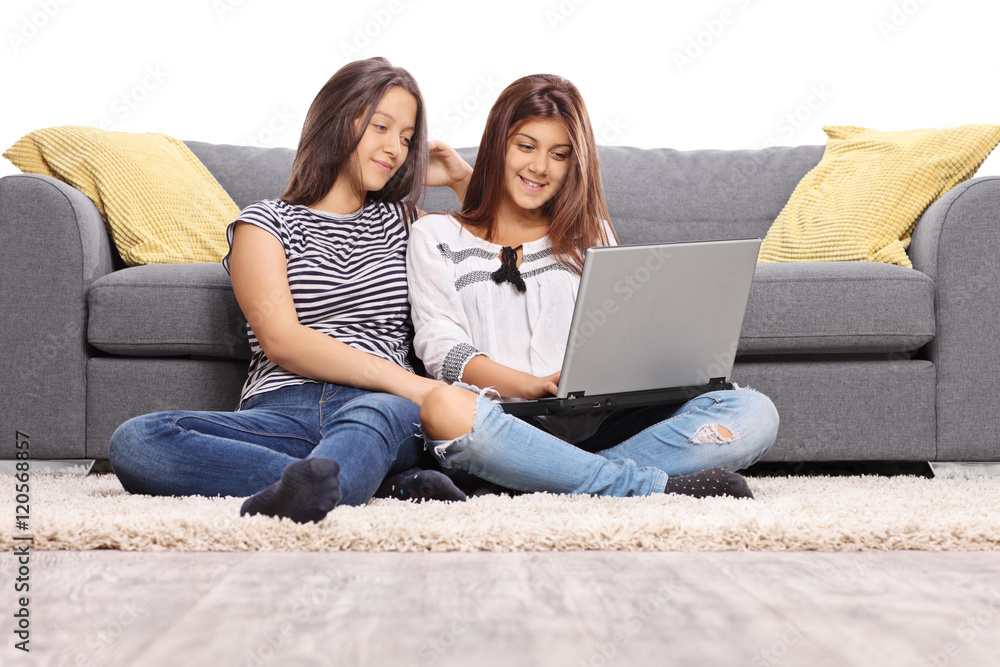 Two teenage girls sitting on the floor