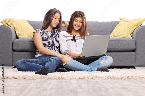 Two teenage girls sitting on the floor