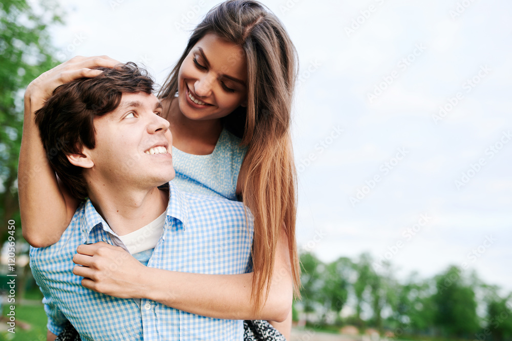 Young happy couple embracing and having fun in the summer in the city Young happy couple embracing and having fun in the summer in the city