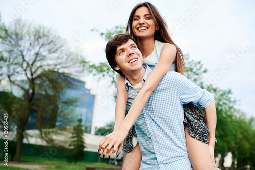 Young happy couple embracing and having fun in the summer in the city