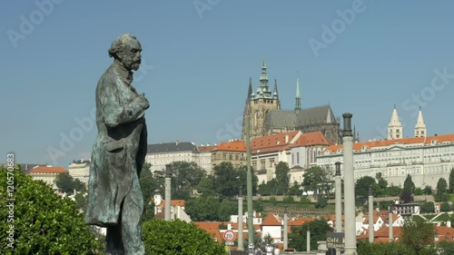 Statue of Antonin Dvorak on Jan Palach Square in Prague. Prague castle and St Vitus cathedral are in the background photo