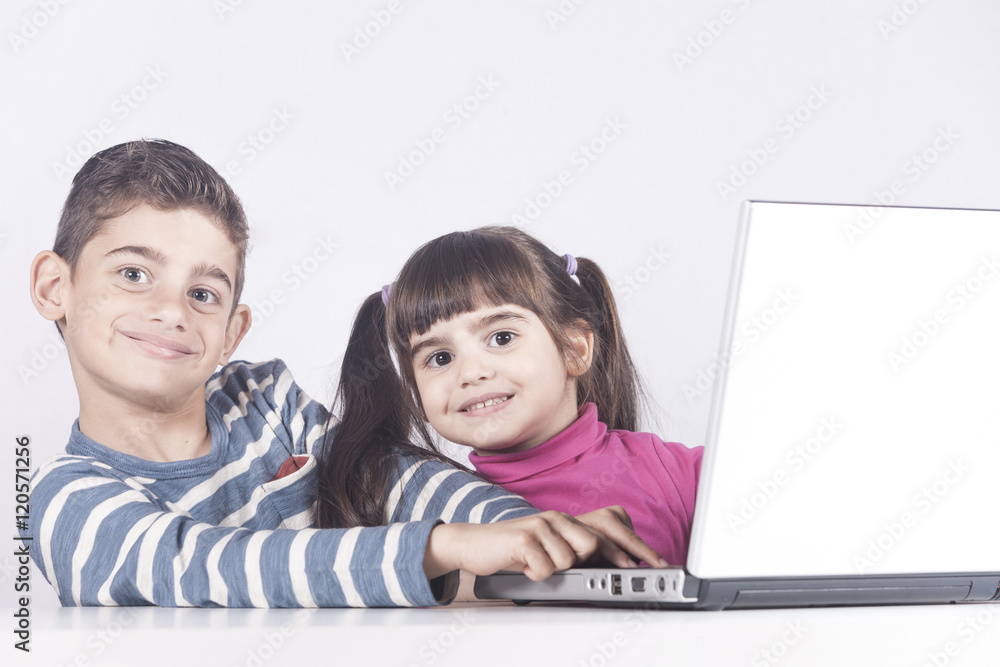 Kids having fun using a laptop computer. Education, technology and e-learning concept Kids having fun using a laptop computer. Education, technology and e-learning concept