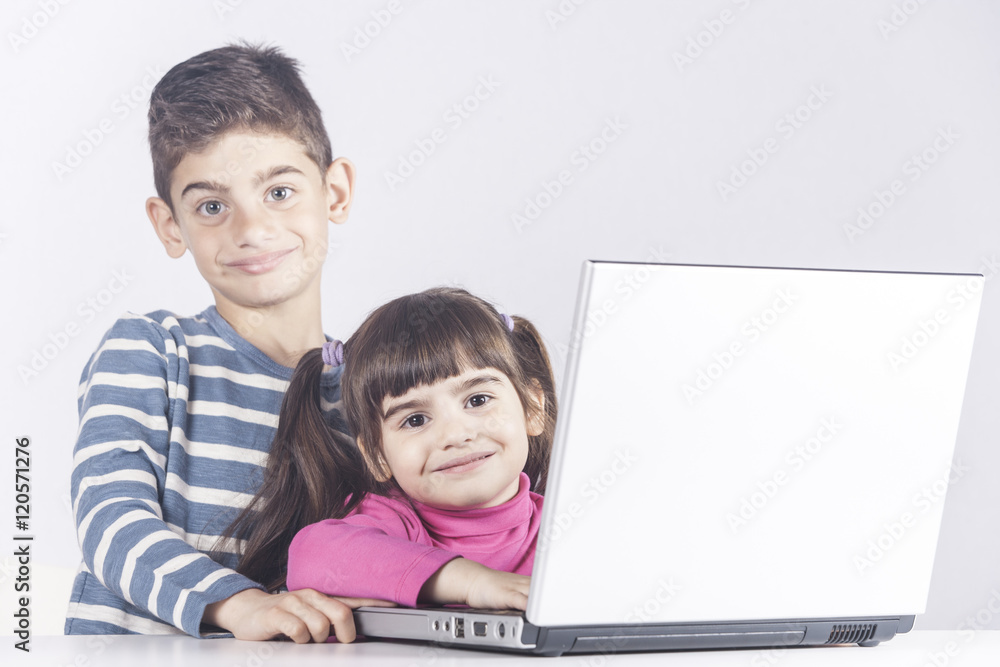 Kids having fun using a laptop computer. Education, technology and e-learning concept Kids having fun using a laptop computer. Education, technology and e-learning concept