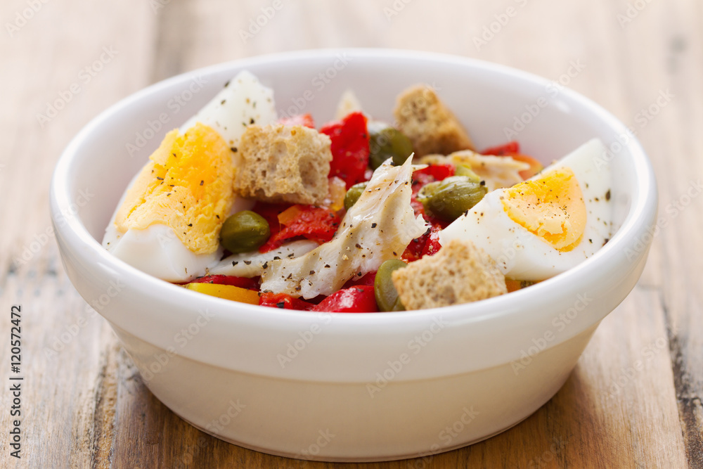 salad with fish and egg in white bowl salad with fish and egg in white bowl