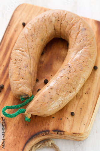 smoked portuguese sausage alheira on wooden board photo