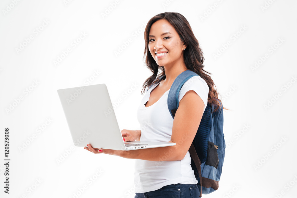 Happy asian student girl with backpack standing and holding laptop Happy asian student girl with backpack standing and holding laptop