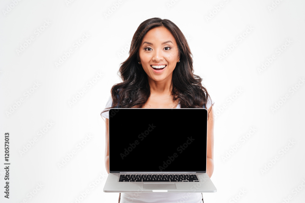 Happy smiling beautiful asian woman holding laptop with blank screen Happy smiling beautiful asian woman holding laptop with blank screen