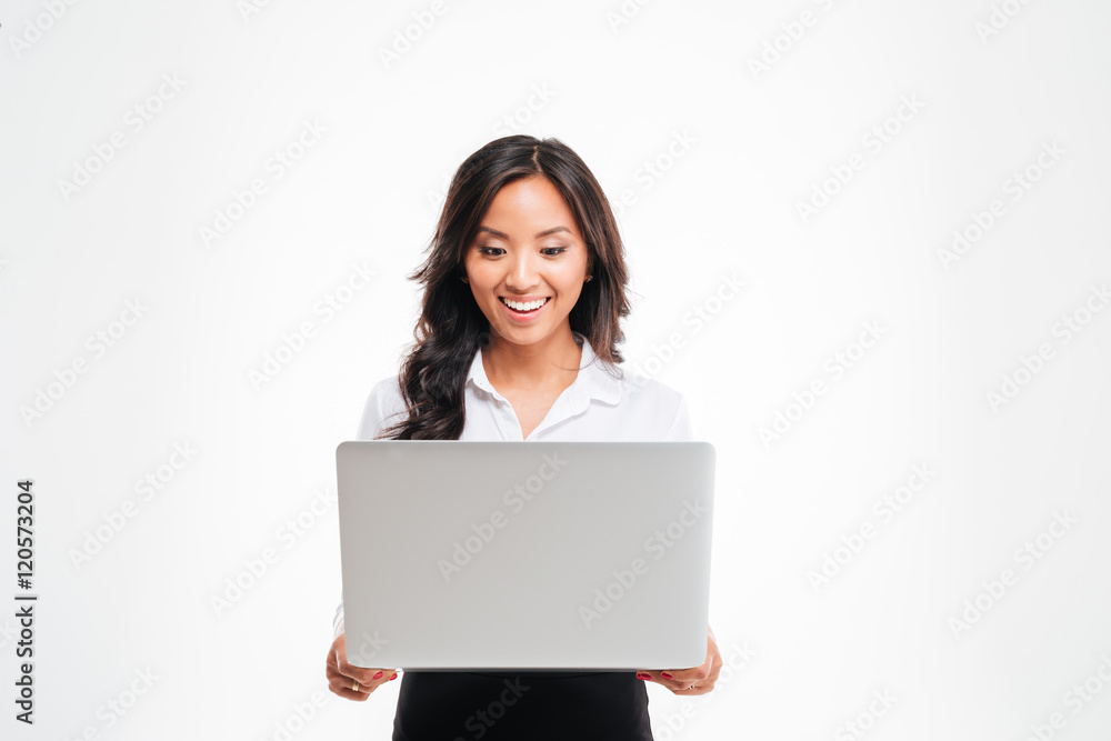 Happy young asian businesswoman standing with laptop Happy young asian businesswoman standing with laptop