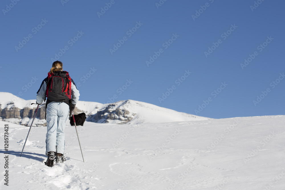 woman hiking with snowshoes woman hiking with snowshoes