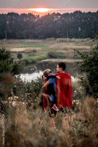 little girl with dad dressed in super heroes, happy loving family © puhimec