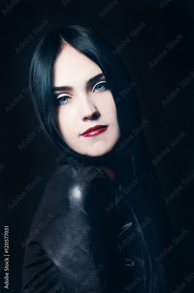 Gorgeous brunette with white skin, red lips on black backdrop Gorgeous brunette with white skin, red lips on black backdrop