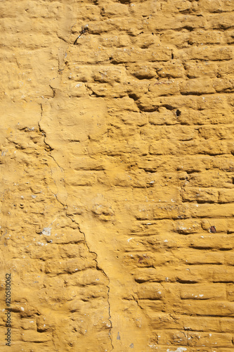Fototapeta Naklejka Na Ścianę i Meble -  vertical part of ochre yellow washed wall