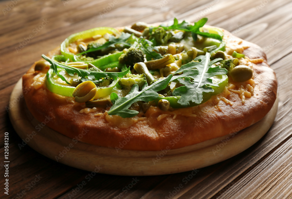 Tasty vegetarian pizza on wooden background Tasty vegetarian pizza on wooden background