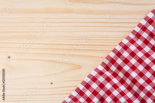 Checkered tablecloth red on the wooden background/ texture 