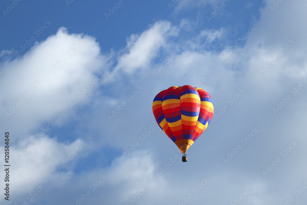 Obraz premium Multi colorful hot air balloon floating in the clouds