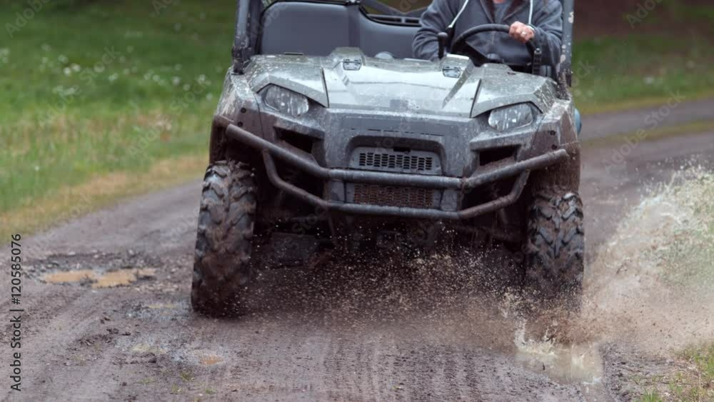 Closeup of atv going through mud in slow motion Closeup of atv going through mud in slow motion