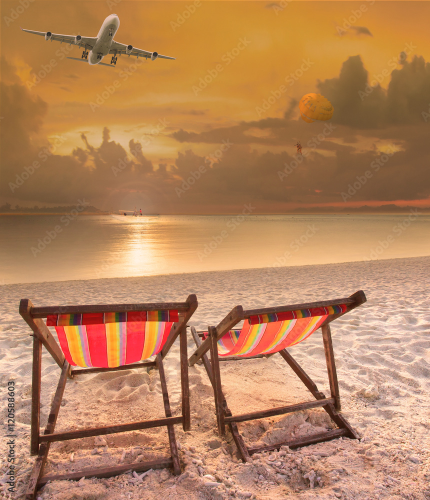 Fototapeta premium beach chairs at sea beach and passenger plane flying above