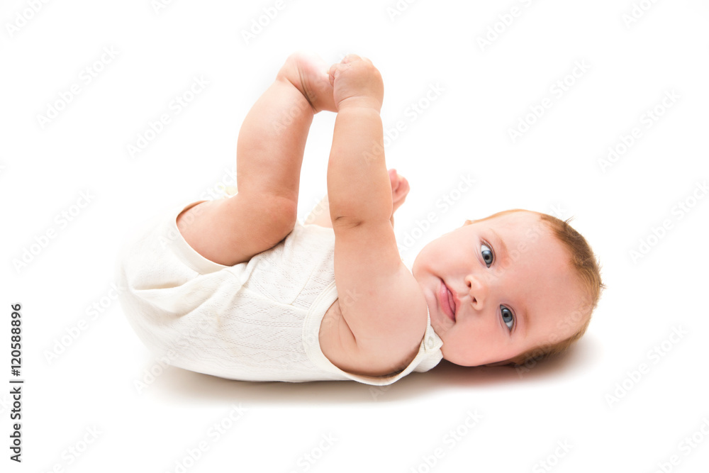Cute kid playing with his feet. Portrait of a beautiful baby girl
Cute kid playing with his feet. Portrait of a beautiful baby girl