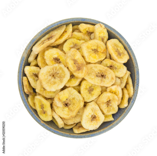 Dried bananas in an old bowl on white background.