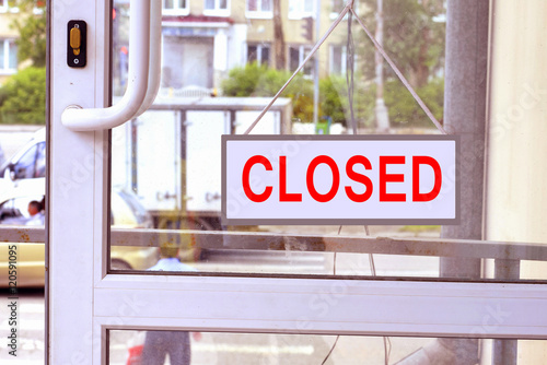 A sign with red letters on the front door