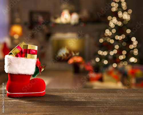 Christmas background with Christmas tree on wooden table. Red, golden and silver ornaments.