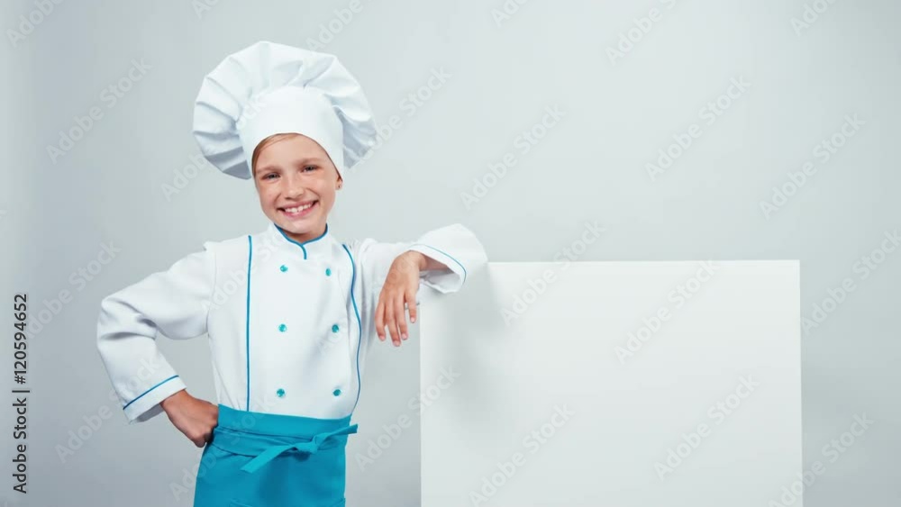 Chef cook child 7-8 years pointing to whiteboard and smiling at camera with teeth. Isolated on white. Thumb up. Ok Chef cook child 7-8 years pointing to whiteboard and smiling at camera with teeth. Isolated on white. Thumb up. Ok