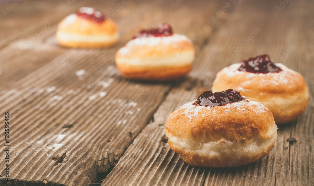 Homemade donuts with jam on wooden table