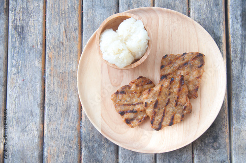 Grill pork with sticky rice on wood plate