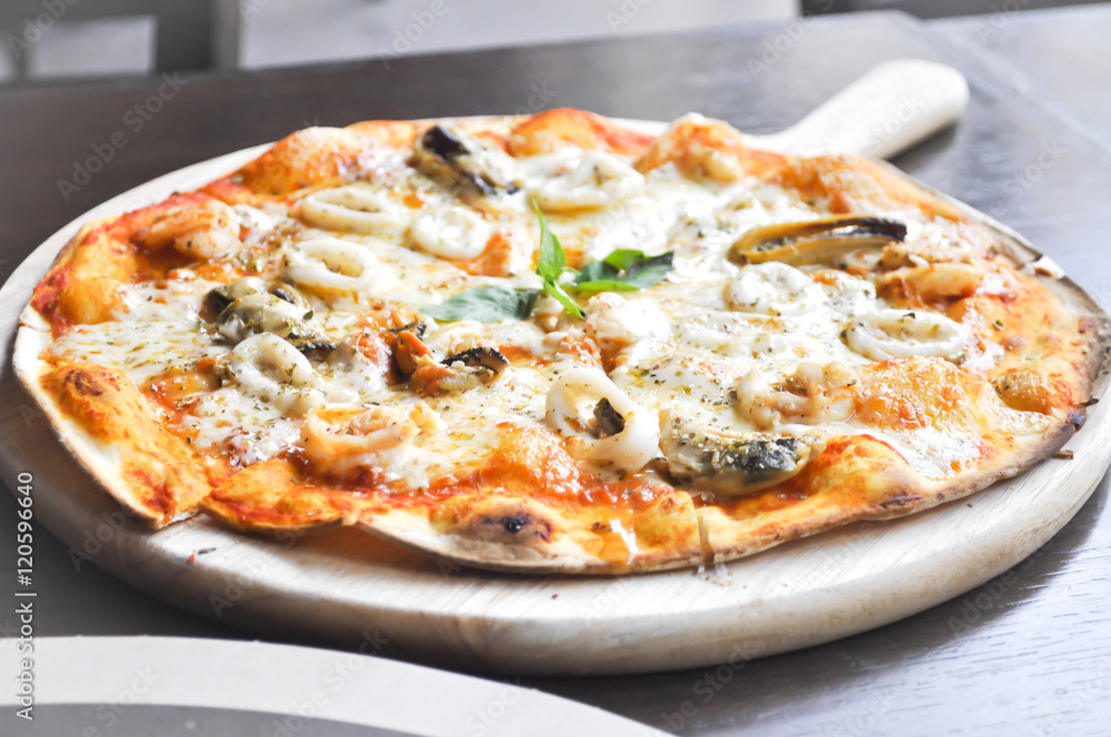 seafood pizza in the wooden tray or thin pizza seafood pizza in the wooden tray or thin pizza