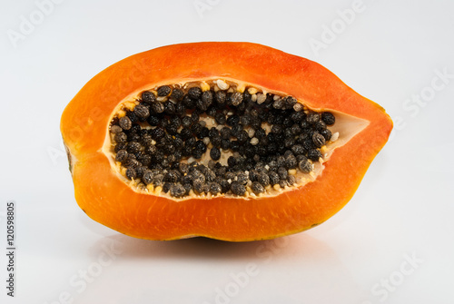 Papaya cut in half on white background