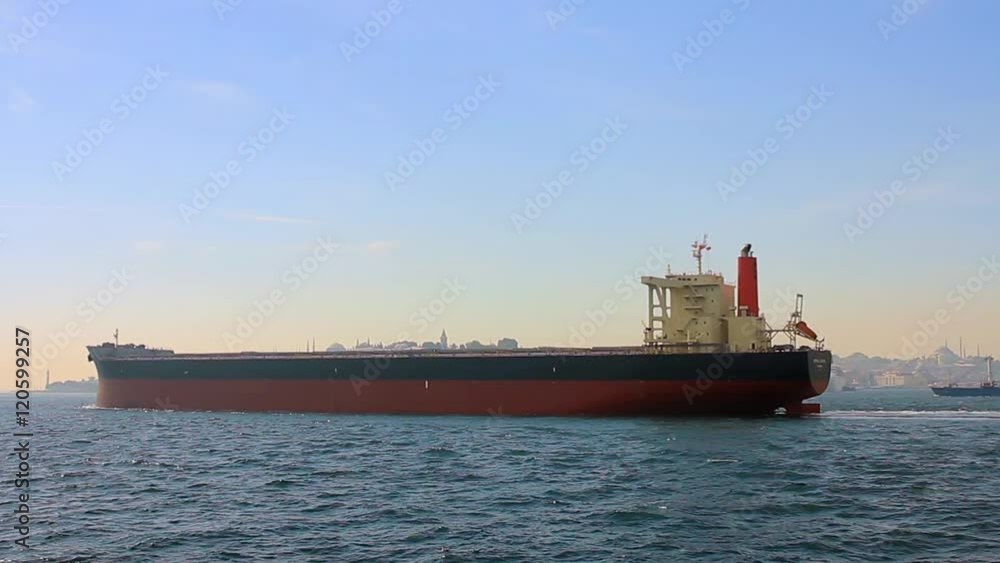 Tanker ship on route to open sea. Side view of the crude oil tanker