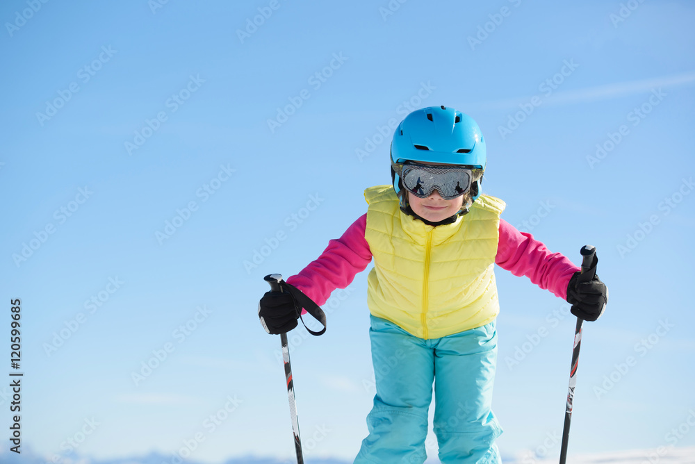  Young skier girl has fun in the mountains during ski holiday