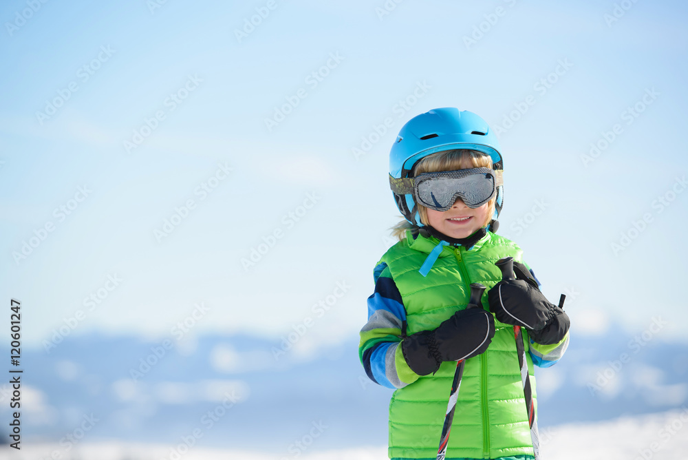 Portrait of a smiling skier boy on a sunny day